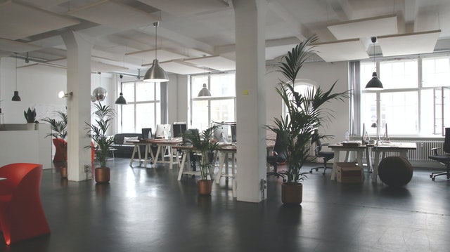 An empty office with black shiny floors and furniture