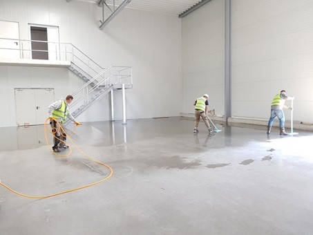 three workers cleaning a facility