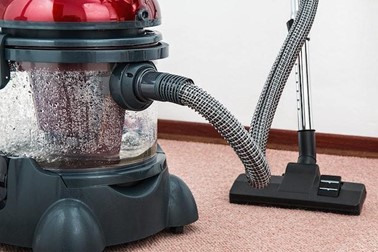 a red and black vacuum cleaner