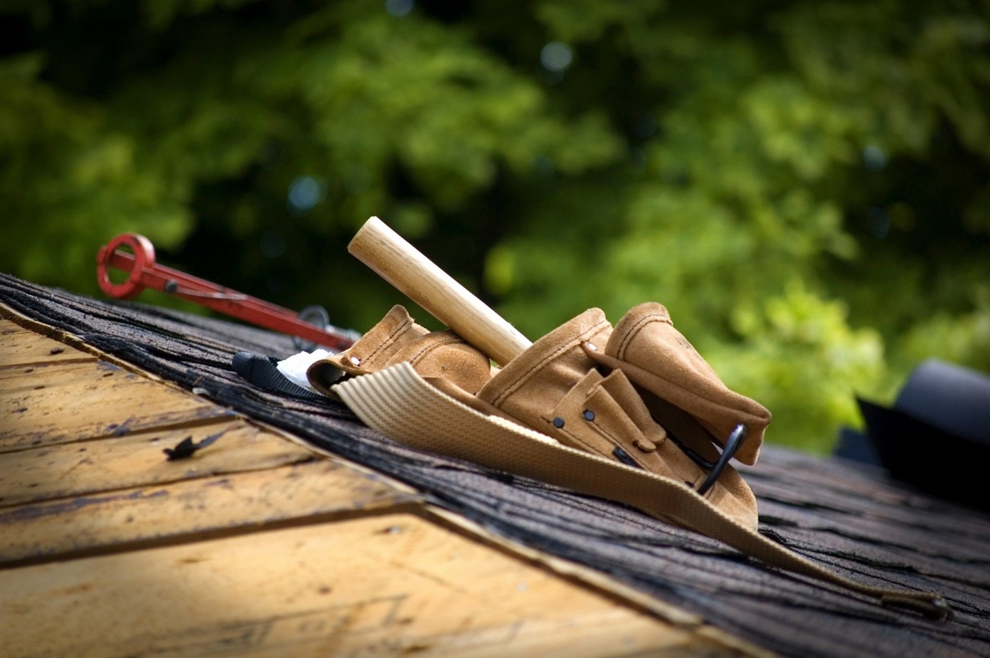 Fixing a roof as part of the ultimate summer building maintenance checklist