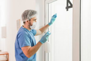 Staff following healthcare facility cleaning requirements.